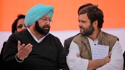 India's ruling Congress party leader Rahul Gandhi, right, speaks with former chief minister of Punjab state Captain Amarinder Singh during an election rally at in Chabal on Wednesday.