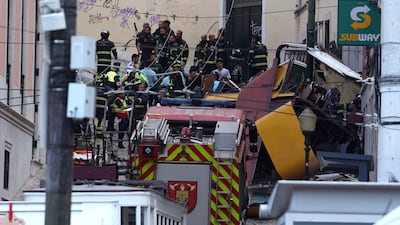 Rescuers at the scene after the Gloria funicular cable railway derailed in Lisbon. EPA
