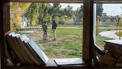 Two Iraqi soldiers standing in front of Urshina bookstore in the city of Sinjar north of Iraq. Haider Husseini for The National