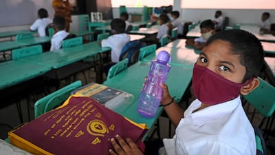 Sri Lankan children wearing face masks sit in a classroom after their school was reopened in Colombo. AFP