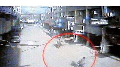 Two gunmen are captured on CCTV walking through the streets of Lahore after the ambush of a bus carrying Sri Lanka's cricketers.