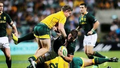 South Africa’s Willem Alberts, centre, is tackled by Australia’s Michael Hooper, top, and Stephen Moore during their Rugby Championship Test match in Perth yesterday.