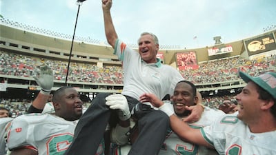 Miami Dolphins coach Don Shula is carried off the field by players Keith Sims, left, and Larry Webster after Miami defeated Philadelphia 19-14 in Philadelphia on November 14, 1993. This win made Shula the most successful coach in the league, giving him his 325th career victory. Reuters