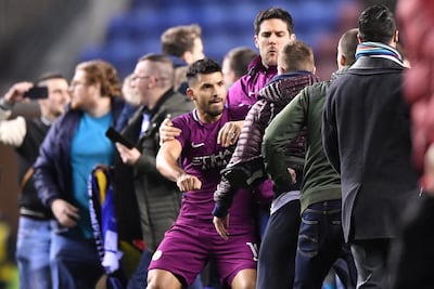 Sergio Aguero of Manchester City is surrounded by fans as he attempts to leave the pitch after the FA Cup fifth-round defeat to Wigan Athletic at DW Stadium. Gareth Copley / Getty Images