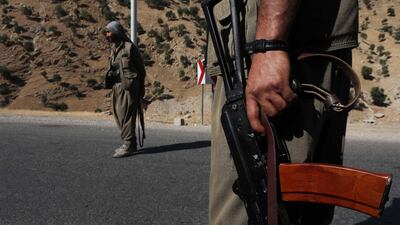 A member of the Kurdistan Workers' Party (PKK) carries an automatic rifle on a road in the Qandil Mountains, the PKK headquarters in northern Iraq, on June 22, 2018. AFP