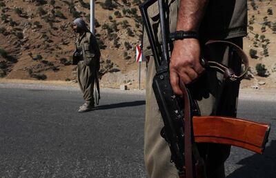 A member of the Kurdistan Workers' Party (PKK) carries an automatic rifle on a road in the Qandil Mountains, the PKK headquarters in northern Iraq, on June 22, 2018. AFP