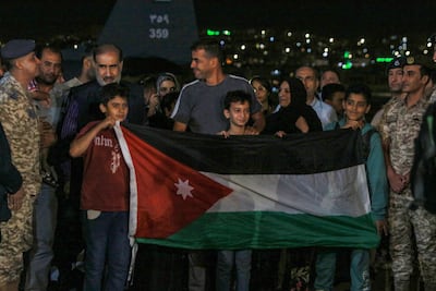 People evacuated from Sudan arrive at a military airport in Amman, Jordan. AFP