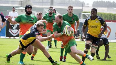 A Dubai Knight Eagles player tries to evade a Hurricanes tackler.