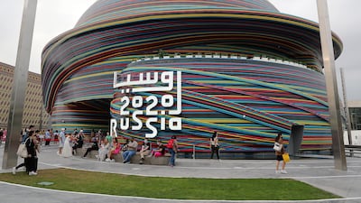 Visitors outside the Russia pavilion, which was closed for some time to repair rain damage.
