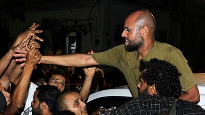 Saif Al-Islam, son of Muammar Gaddafi, greets supporters in Tripoli August 23, 2011. Saif told journalists that Libya, which has been largely overrun in the past 24 hours by rebel forces seeking to topple his father, was in fact in government hands and that Muammar Gaddafi was safe. REUTERS/Paul Hackett (LIBYA - Tags: POLITICS CIVIL UNREST)