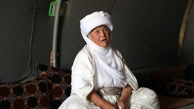 A displaced Iraqi Yazidi woman wearing a traditional outfit, sits inside her tent at a camp for internally displaced people in Khanke, a few kilometres from the Turkish border in Iraq's Dohuk province, on June 24, 2019. AFP
