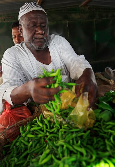 A vegetable vendor sells green chilli peppers at the Al Khaimah market in Khartoum's Arkawit district. Food prices in Sudan have risen sharply in recent months, with the country burdened by a triple-digit inflation. AFP