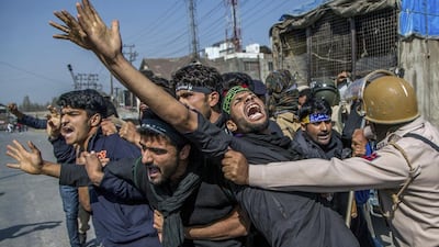 Kashmiri Muslims shout religious and pro-freedom slogans as Indian policemen stop them from from participating in a religious procession during a curfew in Srinagar, India-controlled Kashmir. Dar Yasin / AP Photo / October 10, 2016