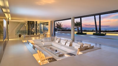 The floor-to-ceiling windows blend indoor and outdoor living.