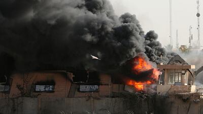 Plumes of smoke rise after a fire broke out at Baghdad's largest ballot box storage site, where ballots from Iraq's May parliamentary elections are stored, in Baghdad, Iraq. Hadi Mizban / AP Photo
