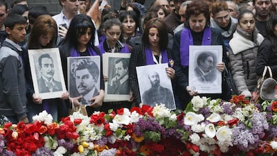 People lay flowers at a memorial to Armenians killed by the Ottoman Turks, as they mark the centenary of the mass killings, in Yerevan on April 24. Sergei Grits/AP Photo