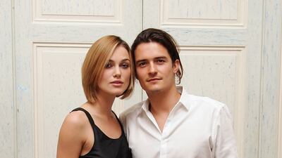 Keira Knightley, in a black full-skirted dress, and Orlando Bloom attend a photo call for 'Pirates of the Caribbean: Dead Man's Chest' at The Dorchester on July 4, 2006 in London, England.