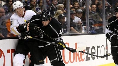 Anaheim's Corey Perry and Robyn Regehr of the Los Angeles Kings clash.