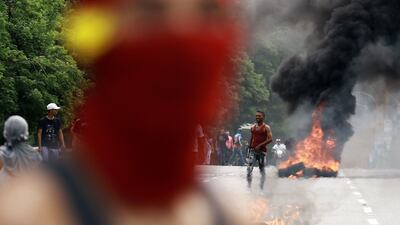 Demonstrators set a barricade on fire during a protest against Venezuelan President Nicolas Maduro's government in Valencia, Carabobo state, Venezuela on July 29, 2024, a day after the Venezuelan presidential election. Protests erupted in parts of Caracas Monday against the re-election victory claimed by Venezuelan President Nicolas Maduro but disputed by the opposition and questioned internationally, AFP journalists observed. (Photo by Juan Carlos HERNANDEZ / AFP)