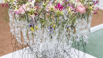 Van Laer's winning work can be seen in the background here: Van Laer chose to intellectualise the brief, rather than taking a literal approach to colour and form – all the more impressive given that this was his first visit to the country. He explains the thinking behind his Dubai-inspired design. “When you look at the shape, it’s a kind of bird to represent Emirates Airlines, and looking from the top-down, it looks like a tower. Inside is a kind of explosion of flowers as Dubai rises up. There is power and movement." Reem Mohammed / The National