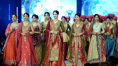 Models present creations by designer Zaheer Abba. Rizwan Tabassum / AFP photo