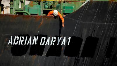 A crew member checks the new name of Iranian oil tanker Grace 1. Reuters