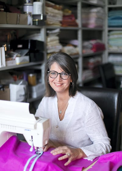 Ceri Rocca, who helps run Rags to Riches UAE, turns discarded bedsheets, towels and blankets into clothes for needy children around the world. Reem Mohammed / The National