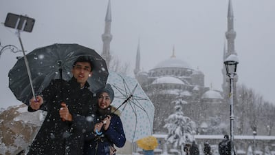 A couple takes a selfie in the Sultanahmet district, one of Istanbul's main tourist attractions on January 9, 2017. Tourism has been affected by the spate of terror attacks in Turkey, causing some residents to be wary and afraid of going out. Emrah Gurel/AP Photos
