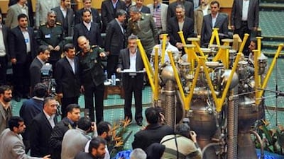 The motor of the Iranian-engineered satellite rocket, Kashgovar 3 (Explorer), is unveiled in Tehran on Wednesday before the president Mahmoud Ahmadinejad, centre left.