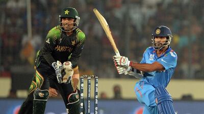 India's Shikhar Dhawan plays a sweep during the T20 World Cup match against Pakistan at the Sher e Bangla National Stadium in Dhaka on March 21, 2014. AFP