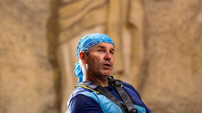 Polish artist Mario, sculptor of St. Simon the Tanner Monastery complex, speaks before a relief depicting Christ with outstretched hands, during an interview with AFP at the church in the Egyptian capital Cairo's eastern hillside Mokattam district. Mario spent more than two decades carving the rugged insides of the seven cave churches and chapels of the rock-hewn St. Simon Monastery and church complex atop Cairo's Mokattam hills, with designs inspired by biblical stories. It was all done to fulfil the wishes of the church's parish priest who met Mario in the early 1990s in Cairo. The Polish artist, who had arrived in Egypt earlier on an educational mission, was then looking for an opportunity to serve God at the monastery. AFP