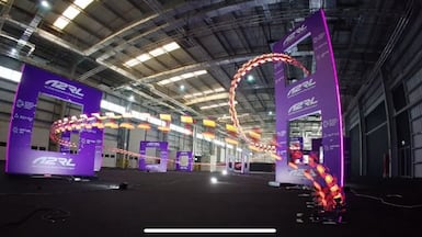 Drones fly through the course at the autonomous drone racing event in Abu Dhabi. Photo: Aspire