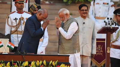 Newly sworn-in Indian Prime Minister Narendra Modi gestures towards Indian President Ram Nath Kovind. AFP