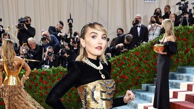 Actress, writer and comedian, Chloe Fineman, wearing a gold, princess-style gown. AFP