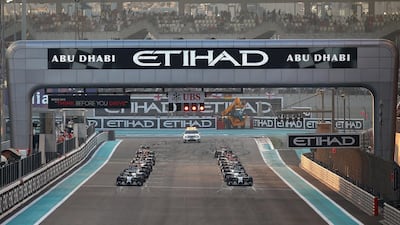 ABU DHABI, UNITED ARAB EMIRATES - NOVEMBER 23: Driver line up on the grid for the Abu Dhabi Formula One Grand Prix at Yas Marina Circuit on November 23, 2014 in Abu Dhabi, United Arab Emirates. (Photo by Mark Thompson/Getty Images)