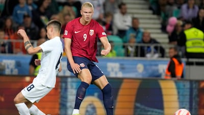 Erling Haaland and Slovenia's Gregor Sikosek challenge for the ball. AP