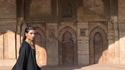 Open-cut black abaya with gold eyelets and hoops from The Edit