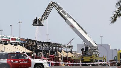 Civil Defence extinguish a fire at the Abu Dhabi fruit and vegetable market in Mina Zayed. Al Ittihad