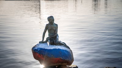 The Little Mermaid sculpture daubed in the colours of the Russian flag. Reuters