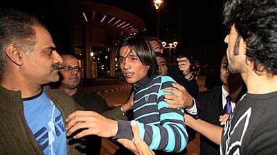 Mohammad Aamer, centre, leaves after appearing before a three-member independent anti-corruption tribunal in Doha yesterday.