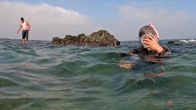 Photographer Mohammed Asad surfaces to take a breath. Reuters