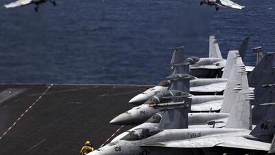 US fighter jets take off for a mission in Iraq from the flight deck of the USS George H.W. Bush in the Arabian Gulf (Photo: AP Photo/Hasan Jamali)