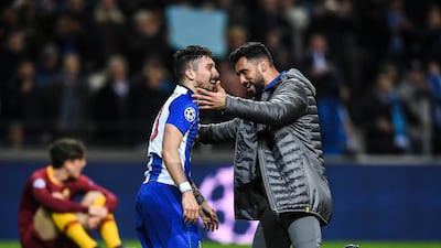 Brazilian defender Alex Telles, left, celebrates Porto's win of their Uefa Champions League last-16 second-leg win over Roma. Patricia de Melo Moreira / AFP