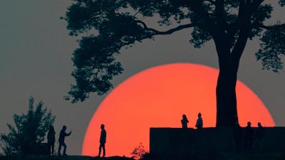 People gather to watch the last sunset of the year 2077 of the Nepali calendar at Single Tree Hill, Kathmandu. The Nepali New Year 2078 began on April 14. EPA