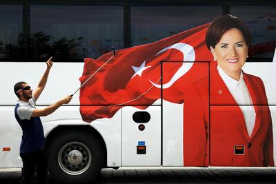 A man takes a selfie next to a bus with a picture of Iyi (Good) Party leader Meral Aksener in Eminonu district in Istanbul, Turkey, June 21, 2018. Alkis Konstantinidis / Reuters
