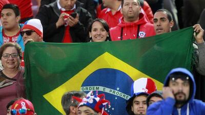 Brazil fans cheer for their team during the 2018 World Cup qualifying match against Chile on Thursday night in Santiago. Claudio Reyes / AFP