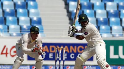 Pakistani captain Misbah-ul-Haq, right, takes a shot during the second day of the 1st Test between Pakistan and Australia at the Dubai International Stadium. Pakistan would go on to win the first Test by 221 runs. Karim Sahib / AFP