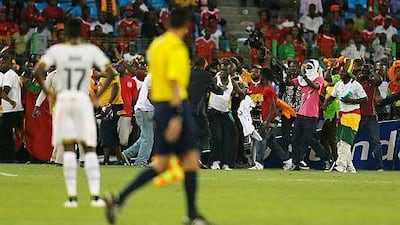 Security officials try to protect Ghana fans after Equatorial Guinea fans threw objects during their African Nations Cup semi-final soccer match in Malabo February 5, 2015. Violent scenes overshadowed the African Nations Cup semi-final as Ghana reached Sunday's final with a 3-0 win over the hosts. REUTERS/Amr Abdallah