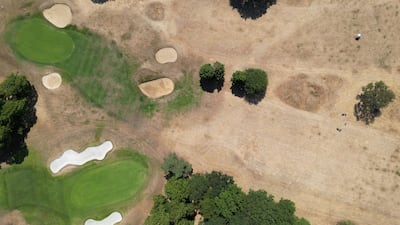 A drone view shows golfers playing on a parched fairway at Royal Mid-Surrey Golf Club. Reuters