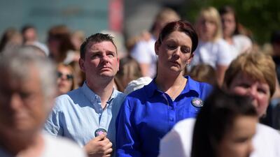 Members of the crowd reflect during the one minute silence. Leon Neal/Getty Images